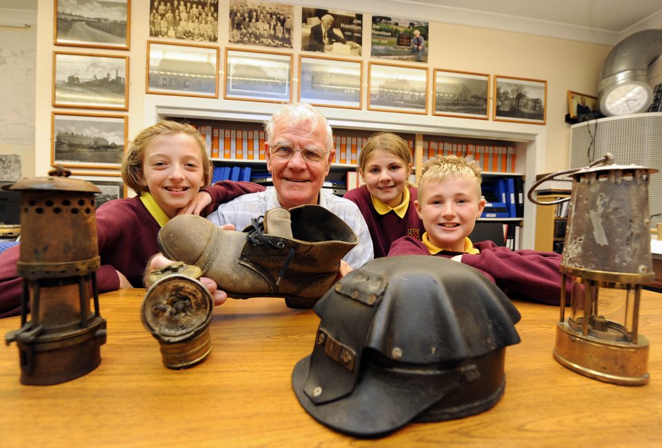 Peter showing pupils of Coalburn Primary School some of the exhibits in the Heritage Centre relating to mining